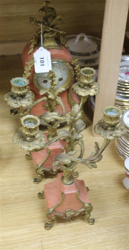 An early 20th century French pink marble clock garniture, 13.5in.